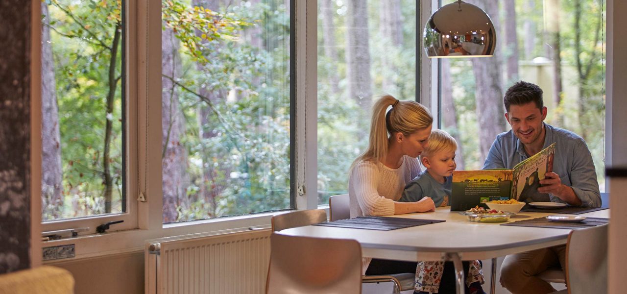 A family reading together in their lodge