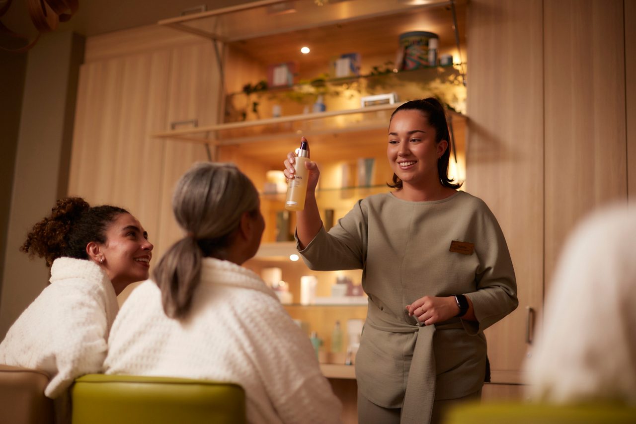 Spa therapist giving a product demonstration.