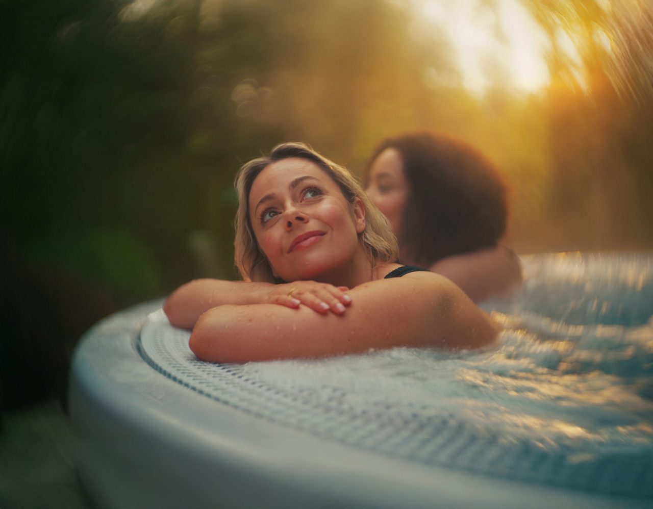 Woman leaning on the edge of a hot tub.