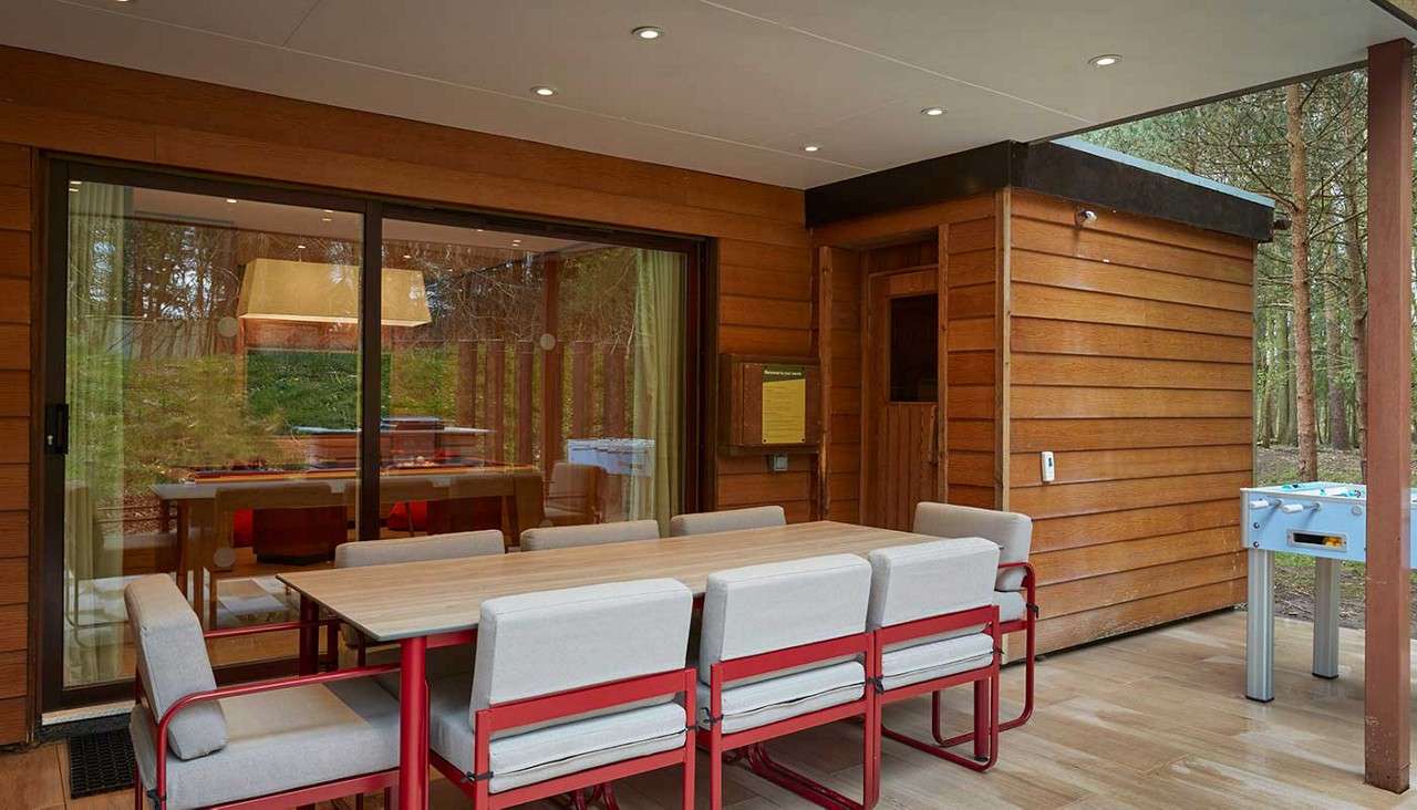 Outside seating area with pergola and football table.