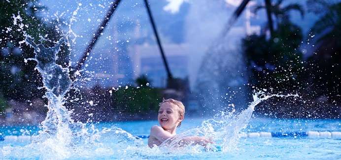 A boy splashing in the Subtropical Swimming Paradise