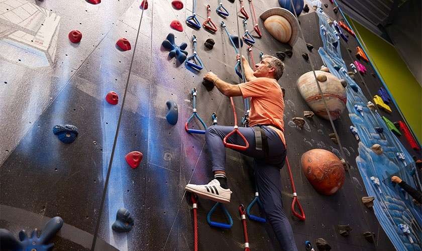 A man climbing a climbing wall