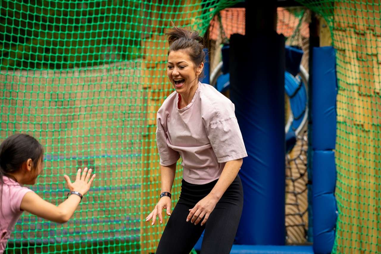 Woman jumping suspended nets.