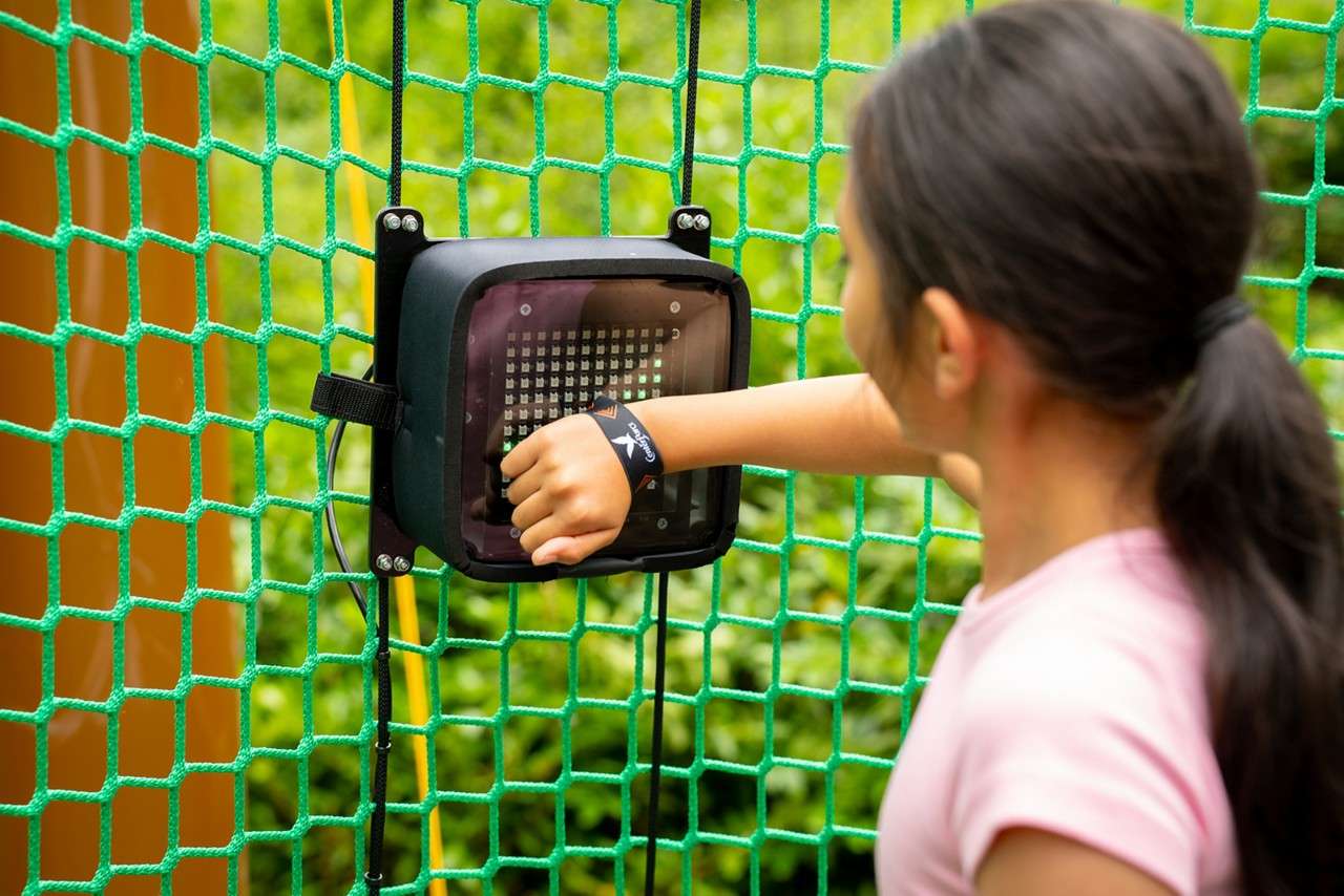 Young girl collecting TAGs around the Adventure Nets course.