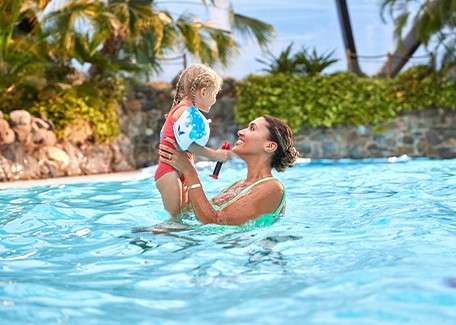 A mother and her child swimming in the indoor pool in the Subtropical Swimming Paradise.