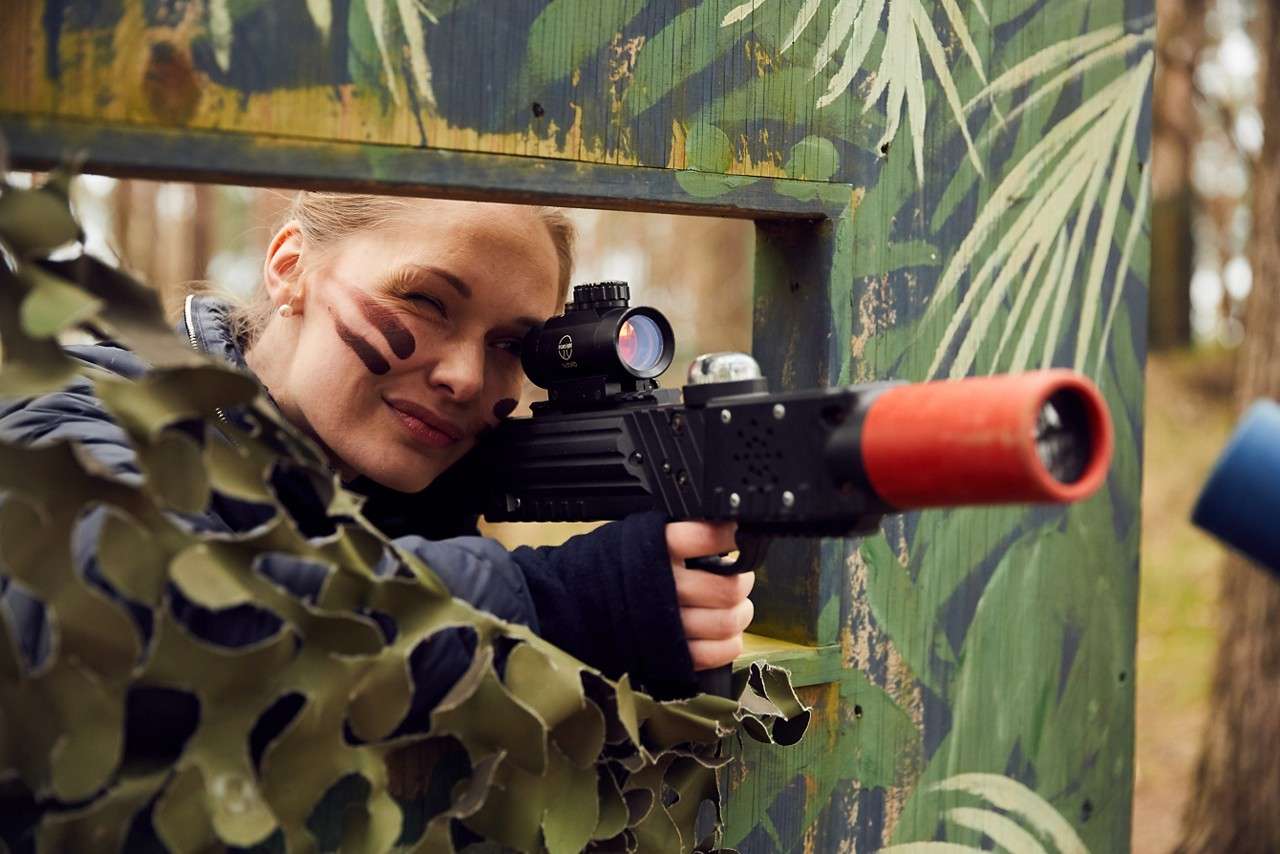 A lady taking aim in Laser Shock