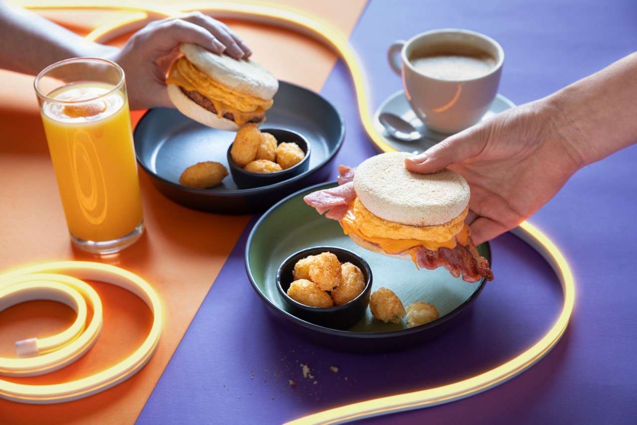 Breakfast muffins served with hash brown bites.