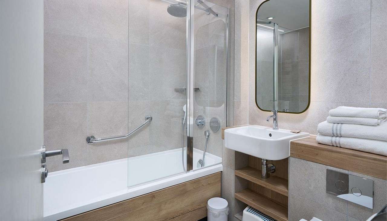 Bathroom with bath and built in shower.