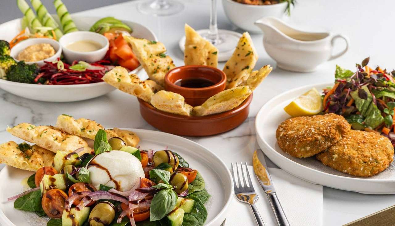 A selection of fishcakes and salads.