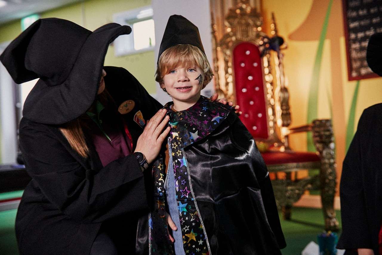 Young boy dressing as a wizard.