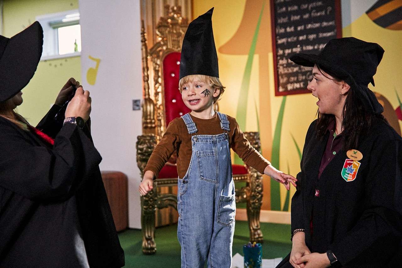 Young boy dressing up as a wizard.