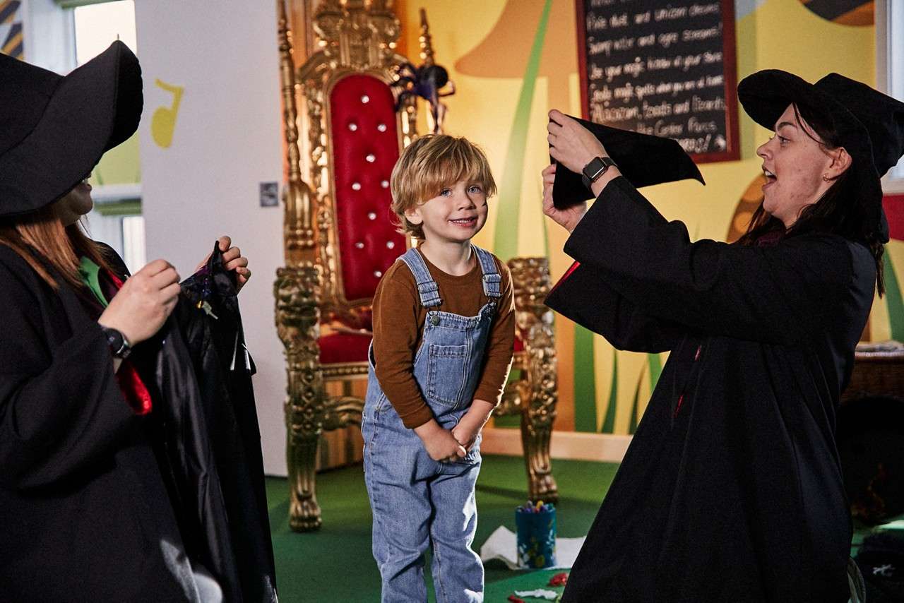 Young boy dressing as a wizard.