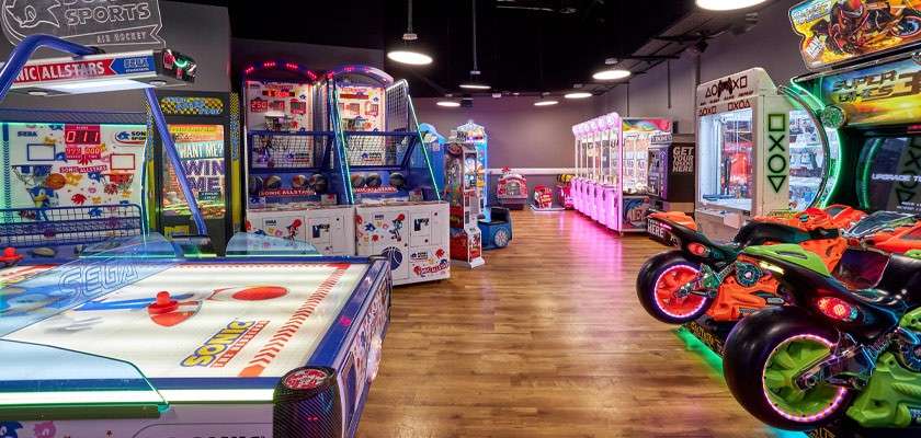 Young boy playing on an ice hockey table in an arcade