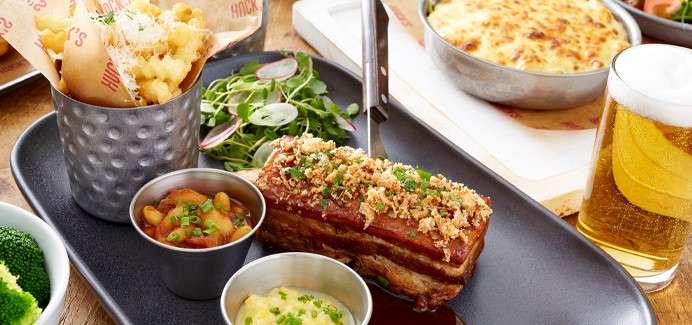 Pork belly served withchips, salad and dips.