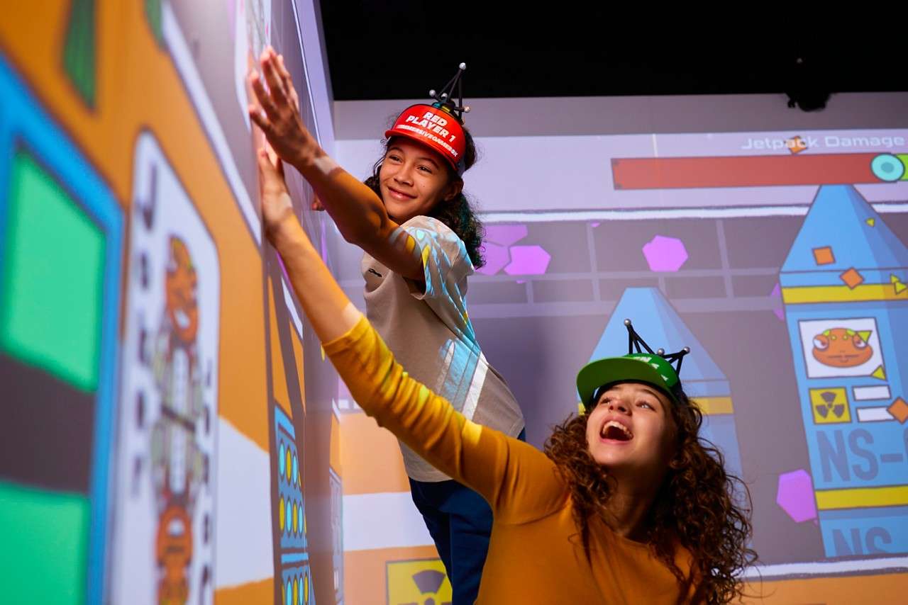 Group in a room with projections