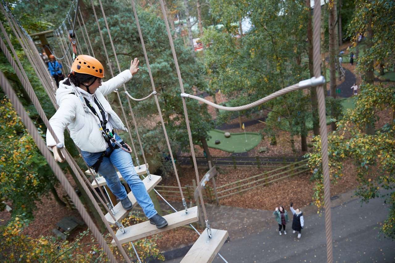 Woman waving to people on the ground.