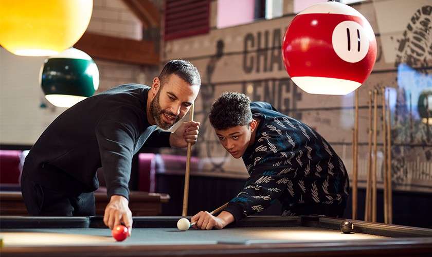 Father and son playing pool together in the Sports Cafe.