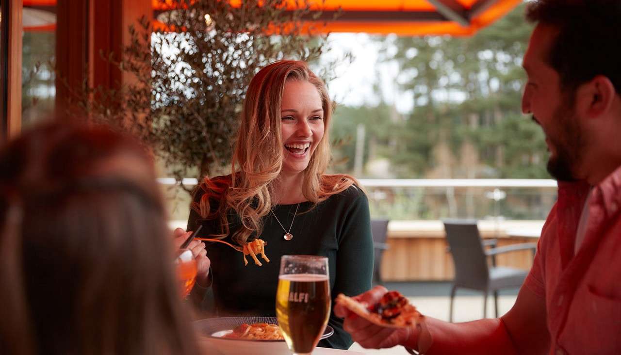 A family eating Italian food alfresco 
