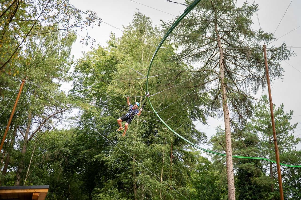 Man gliding across the Treetop Glider.
