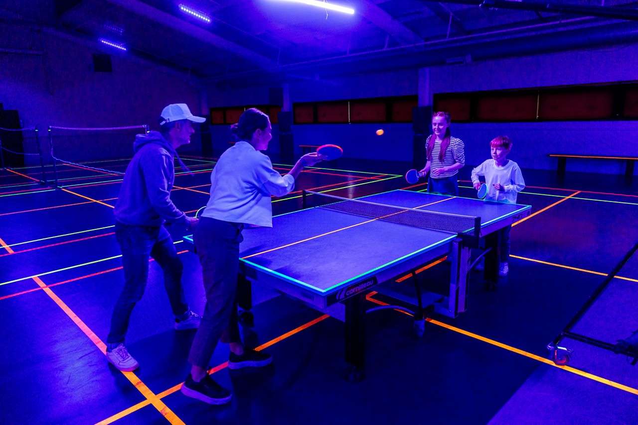 Young person and an adult playing with slime.