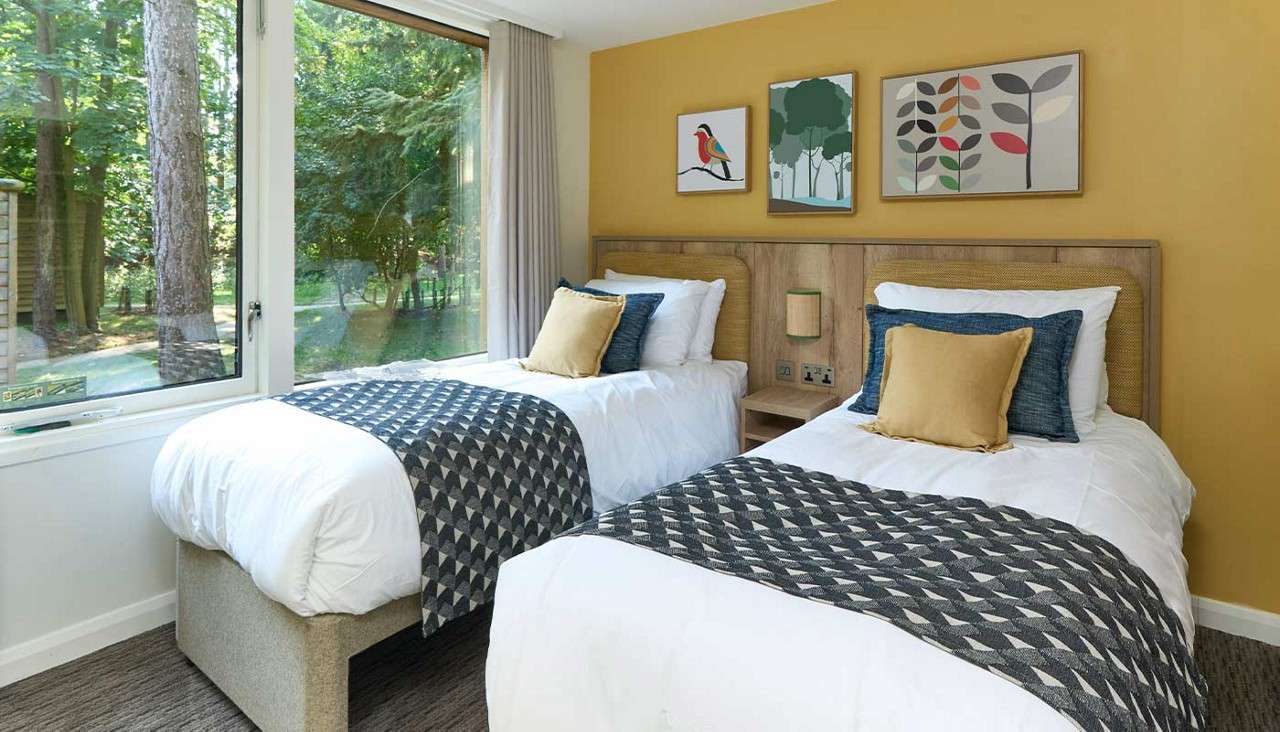 Twin bedroom with large window.