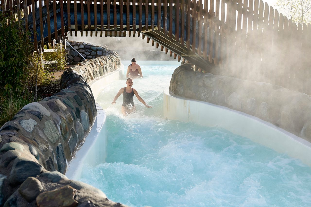 Two people splashing down the Wild Water Rapids.