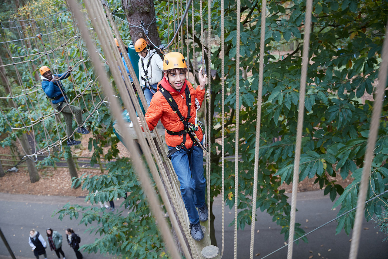 Boy gliding through the trees on Aerial Adventure.