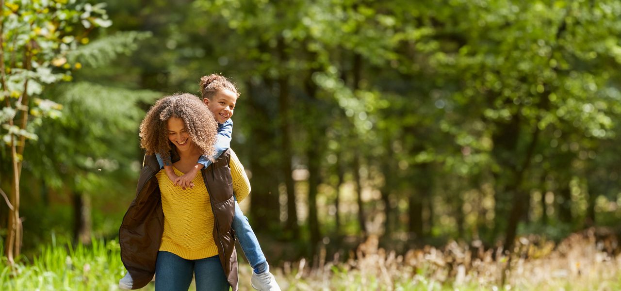 A mother and daughter exploring the forest