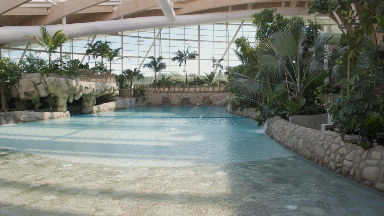 The inside of the Subtropical Swimming Paradise, lit up at night time. 