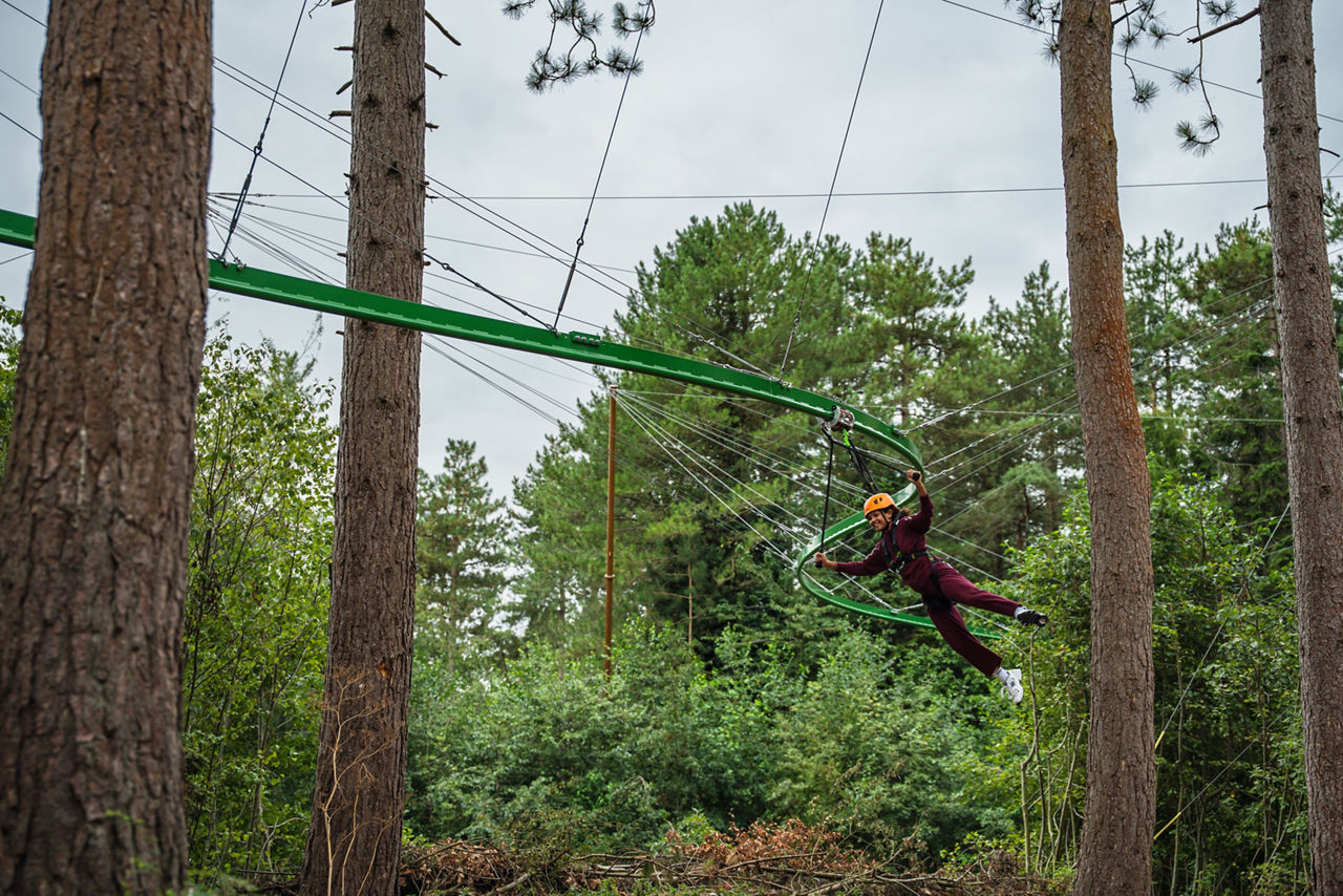 Person flying down a zip wire.
